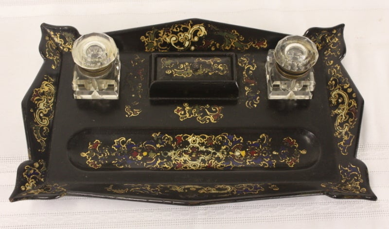 Antique black papier mâché inkstand ornately hand-painted, with original inkwells, little lidded stamp box and place for pens. Quite good condition.