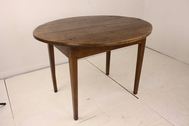 This is a very good size for a country breakfast table, it is a very pretty oval. The poplar wood offers great color, grain and patina. Two drawers, one on each longer side, have a hand-wrought round handle. Very nice classic tapered legs.