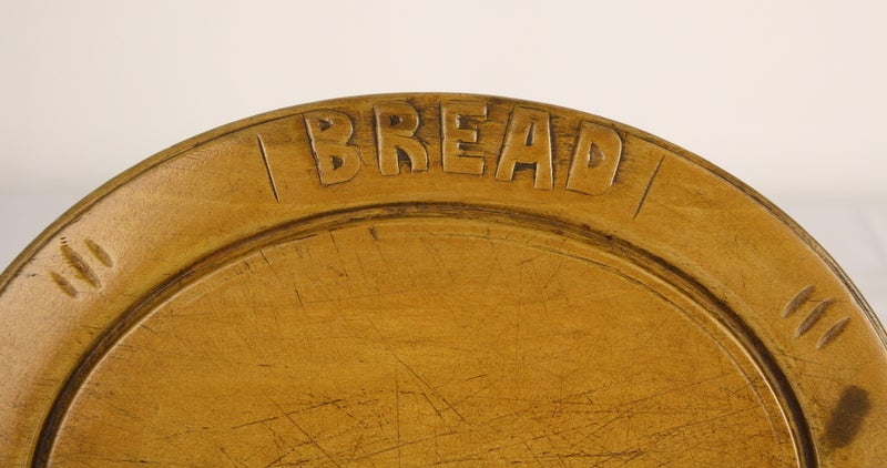 This oval shaped bread board is unique. Very charming. The knife that accompanies the cutting board is carved to simulate a sheaf of wheat. With a good sharpening, this is a very usable knife. The measurements below are for the breadboard. The knife