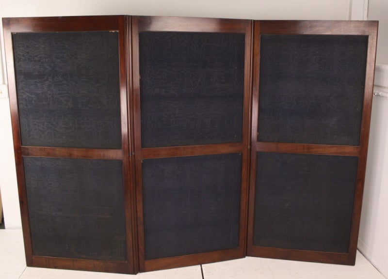 Very elegant Georgian room-divider screen, in fine, glowing mahogany. Original flat ruler hinges are in good working order. Folds easily and is two-sided. The fabric is a darker moire and can be easily replaced if desired-it does show slight damage