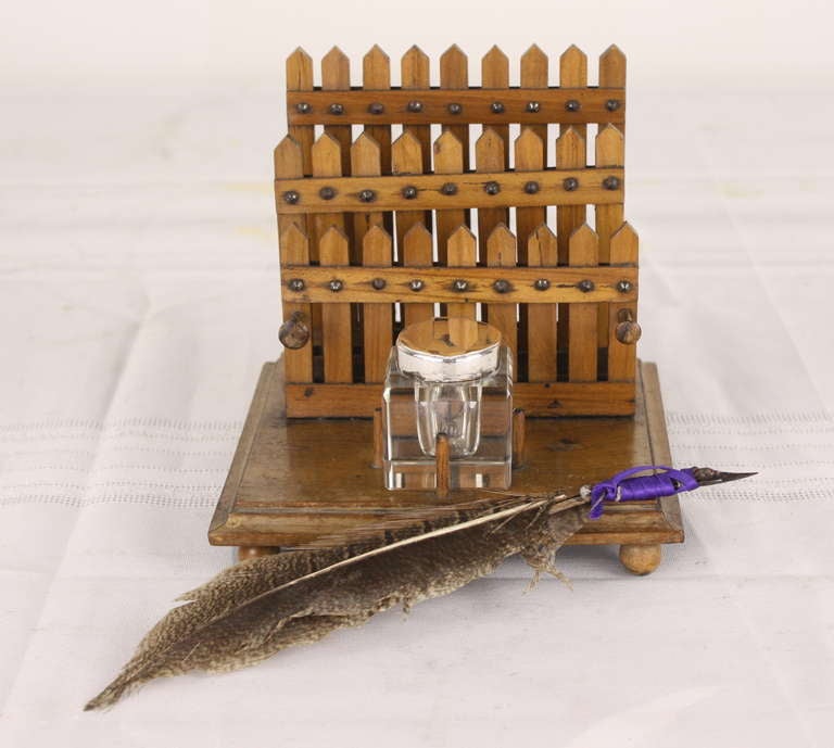 Charming and unique little desk accessory. Picket fence letter rack, place to hold a pen, and a lovely silver plate top inkwell. Feather pen.