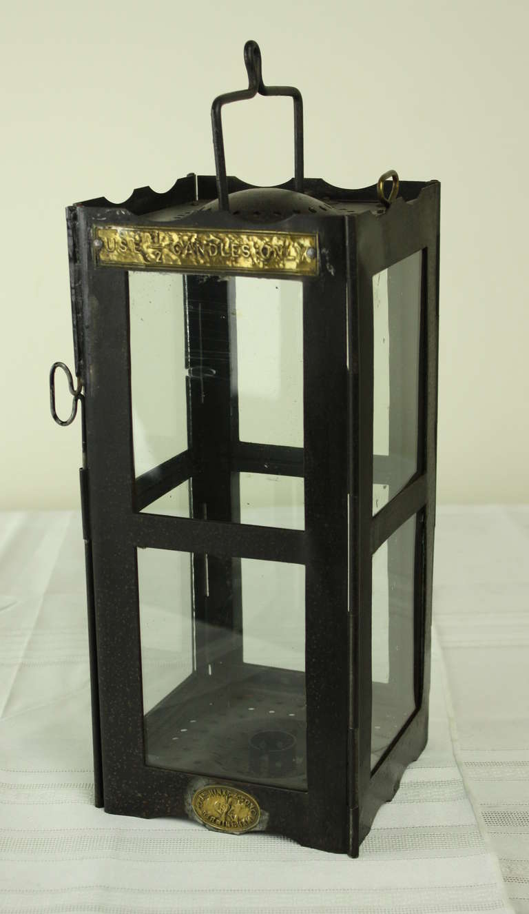 Charming black iron candleholder, sweet for the table, but good also for a visit to the stable!  Brass plaque on top says 