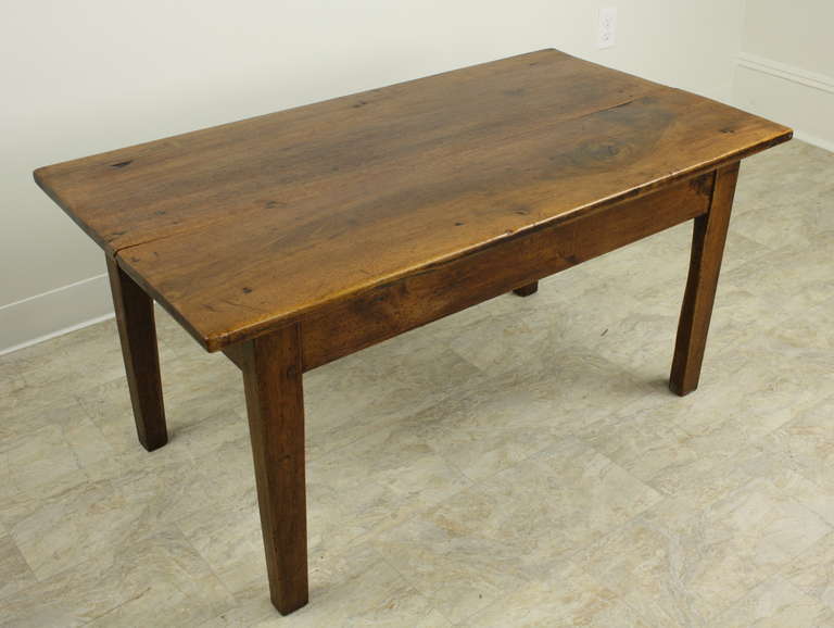 Walnut is a lovely wood, and this table is a very good example of why walnut is so desirable.  The graining is beautiful. This coffee table is a nice medium size, with classic French tapered legs.  Very handsome, with some old distress for interest.