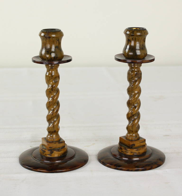 In a faux tortoise these are fun and amusing, simulation the real thing, and mimicking the shape of wood barley twist candlesticks from an earlier period. Little metal cups in the tops will hold your candles straighter. Previous repair to the tops,