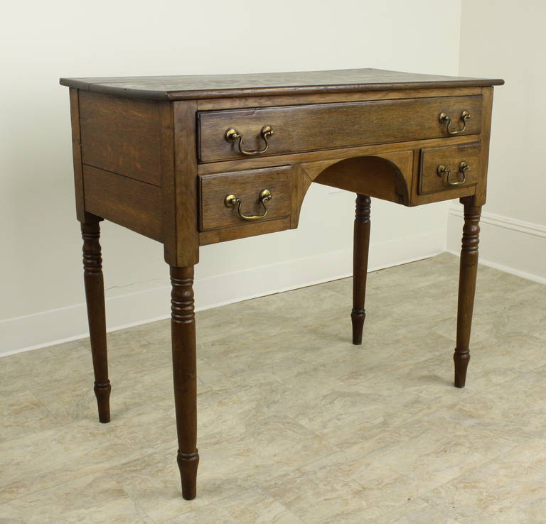 Classic and perfectly shaped Welsh oak lowboy. Beautifully aged,  great color and patina. Note the old blue paper lining in the drawers, an indication of the Georgian period. Legs are exceptionally turned, drawers have lovely molded edges. Original
