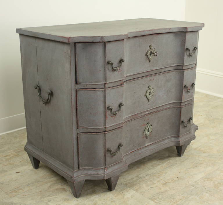 In a charming smaller size, this delightful chest has the original bronze handles and escutcheons, the paint has been refreshed recently, in gray-blue, over the earlier red and gray paint.The shape is great, in the classic shape, with the most