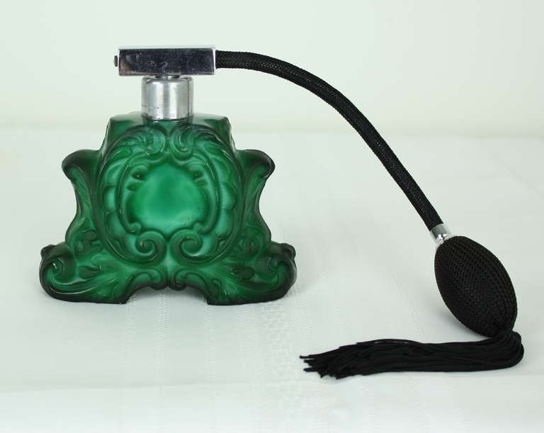 A very interesting example of a hand-carved and polished glass perfume bottle, made to appear as malachite, this was a most popular style of perfume bottle in the 1930s, and was produced in Czechoslovakia primarily. The owner must have prized this
