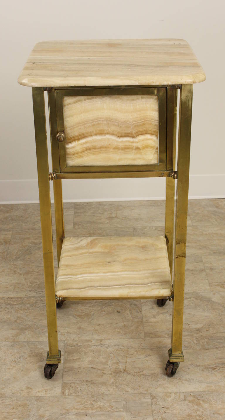 A most interesting night stand.  The marble is very pretty, the grain of which is quite unique.  One cubby for storage.  The brass appears to have been lacquered in the past to prevent tarnishing, and is therefore a little dull, but it looks fine to