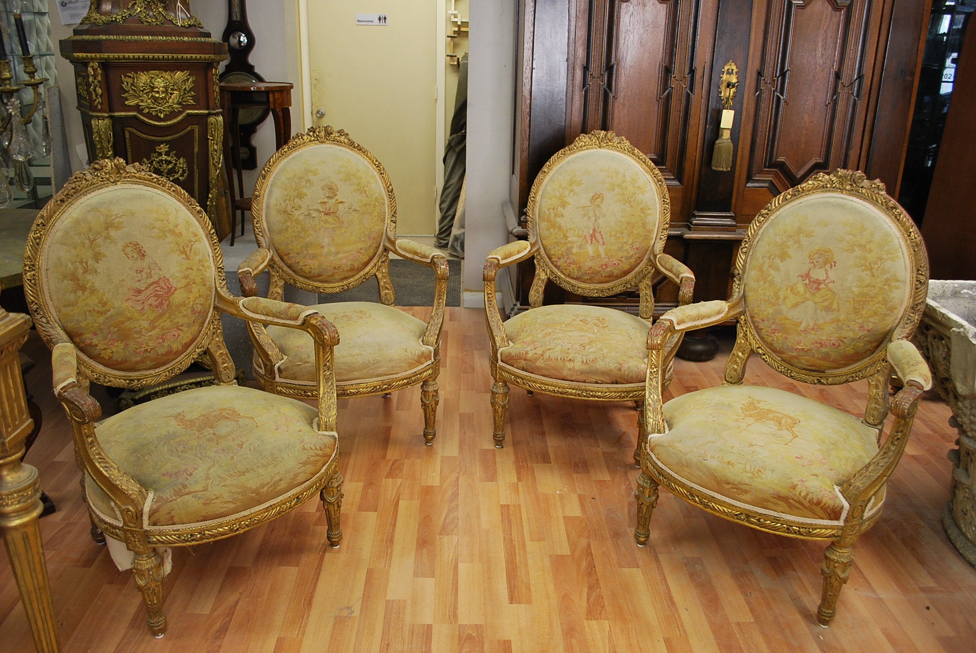 Set of four french gilded wood & nedllepoint Louis XVI Style Fauteuils
