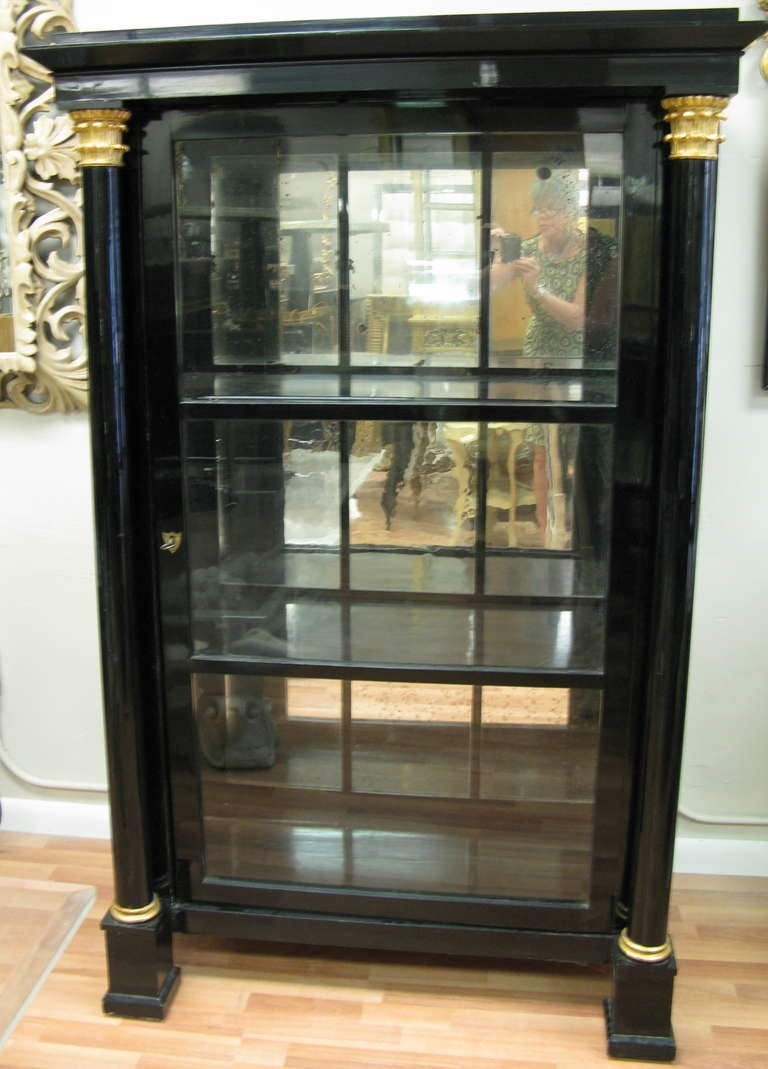 Striking Biedermeier Black Lacquer Cabinet.
This circa 1820 Cabinet has most of the original Mirrored Panels at the back.
Free-standing Corinthian Columns with Gilt Wood Trim.
 Fitted interior with 2 shelves and Mirrored Back Panels.