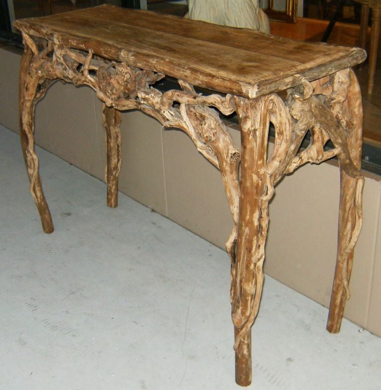 Incredible console table in a sculptural form comprised of gnarled and twisted natural driftwood.