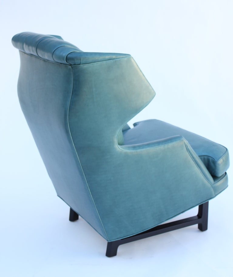 Classic Janus collection wing chair. Designed in 1957 for the Dunbar’s most well heeded collection, Janus by Edward Wormley. Leather Upholstery and signed with the original decking.