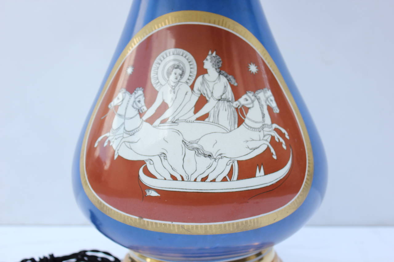Unique Italian porcelain lamp depicting a surrealist dream coming from the top of head. Notice the eye at the base of the lamp. The opposite side depicts Pegasus with a chariot. No markings. Gold-plated base. Gilt cap. Rewired. In the manner of