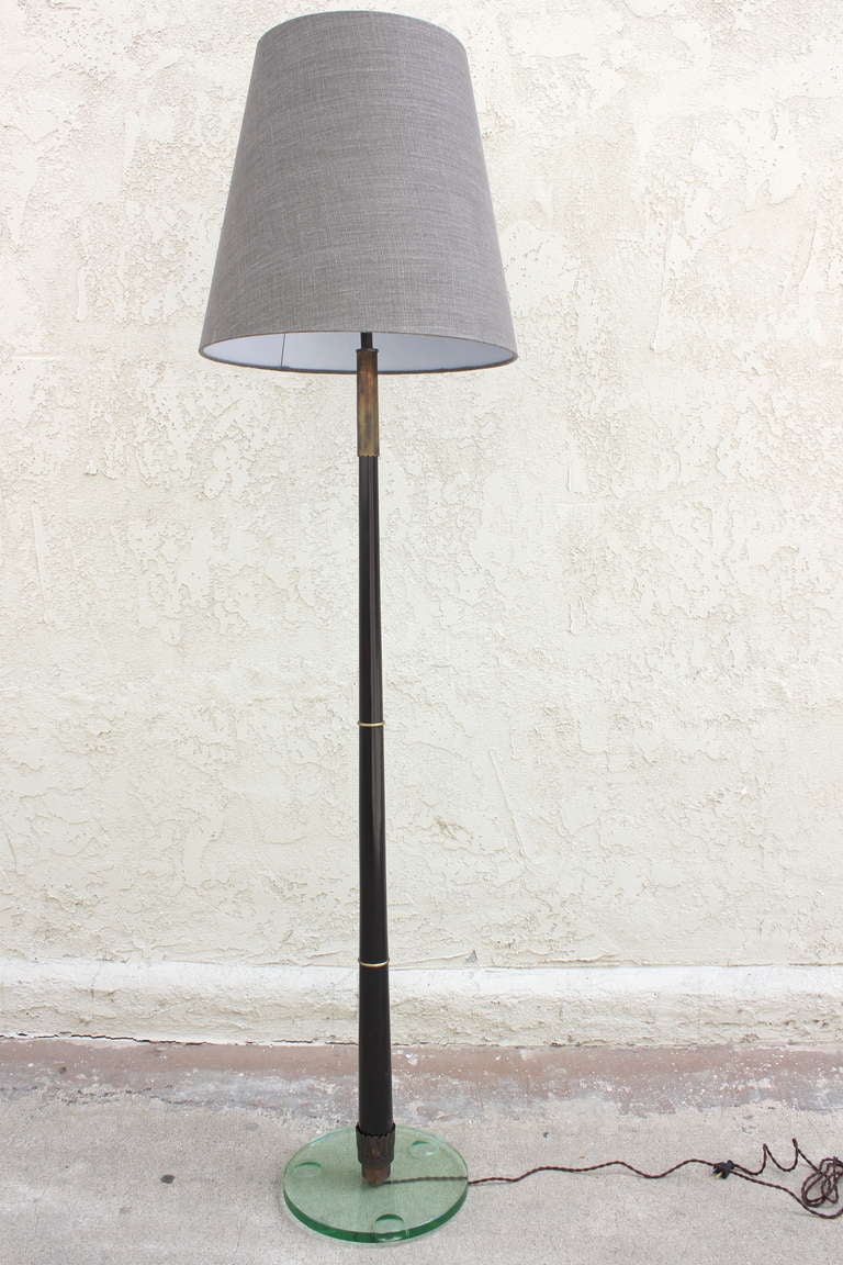 Mahogany and Brass Floor Lamp with Glass Base.
The Custom lamp shade is included and measures 20.5