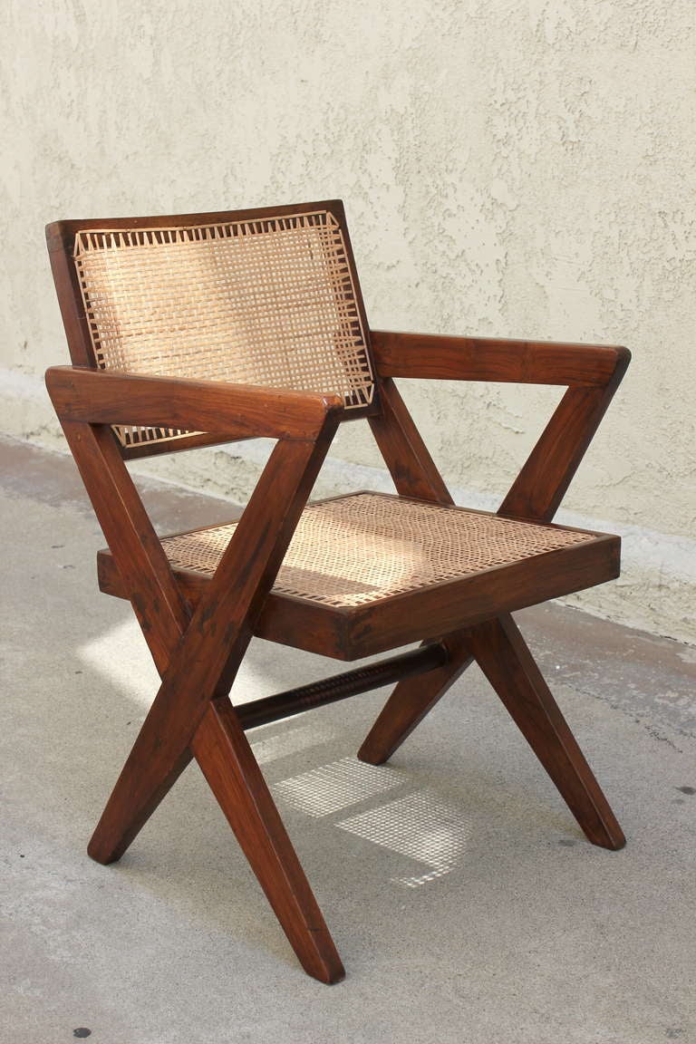 Pair of Pierre Jeanneret Armchairs from Chandigarh. Teak, Cane, cushions ( not shown)
Proportions vary.
