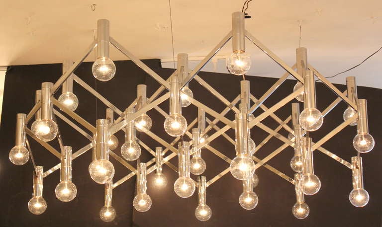 35 light Ott International chandeliers. Chrome. 1970s. Original finish. Slight oxidation. Cable installation.