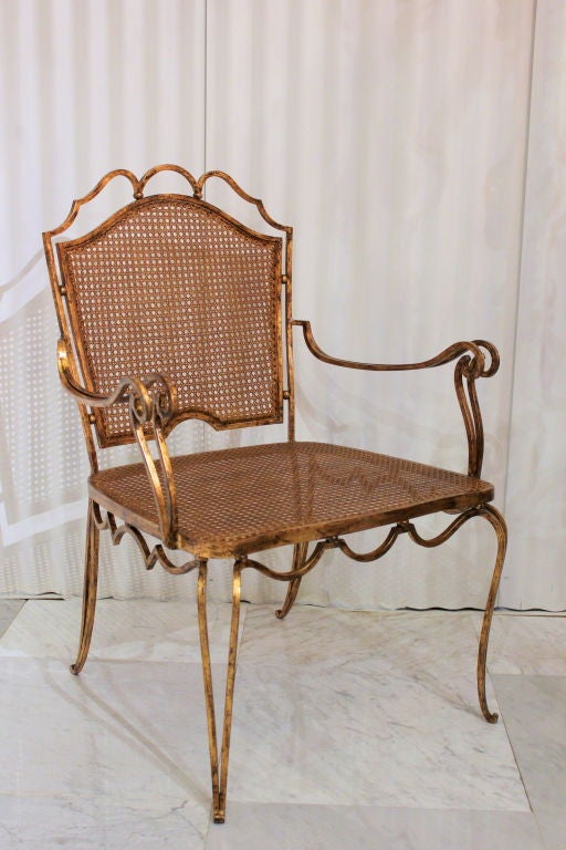 Arturo Pani gilt over iron and hand caned chair. Pani is well-known for the juxtaposition of Classic forms and Mexican materials. 
Price is per chair.

Three chairs available.