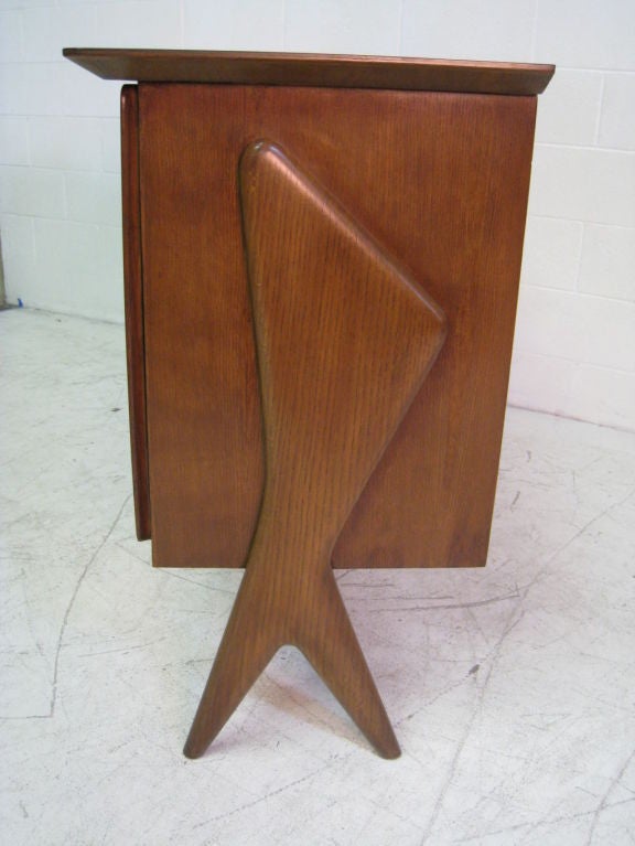 Two-door teak cabinet from 1954 with sculptural side. Support and door handles. A-symmetrical top. Interior shelves. Produced by Fratelli Rizzi, Capiago Intimiano Italy. See Phillips de Pury Auction Catalog, June 2008 New York, Lot 51 for larger