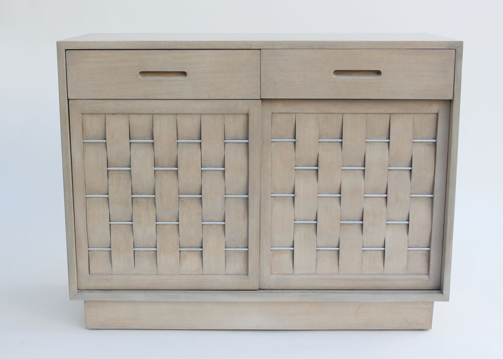 Woven Front Cabinet with Aluminum Rods.  Drift Wood Finish.  Two drawers across the front and 3 internal drawers.