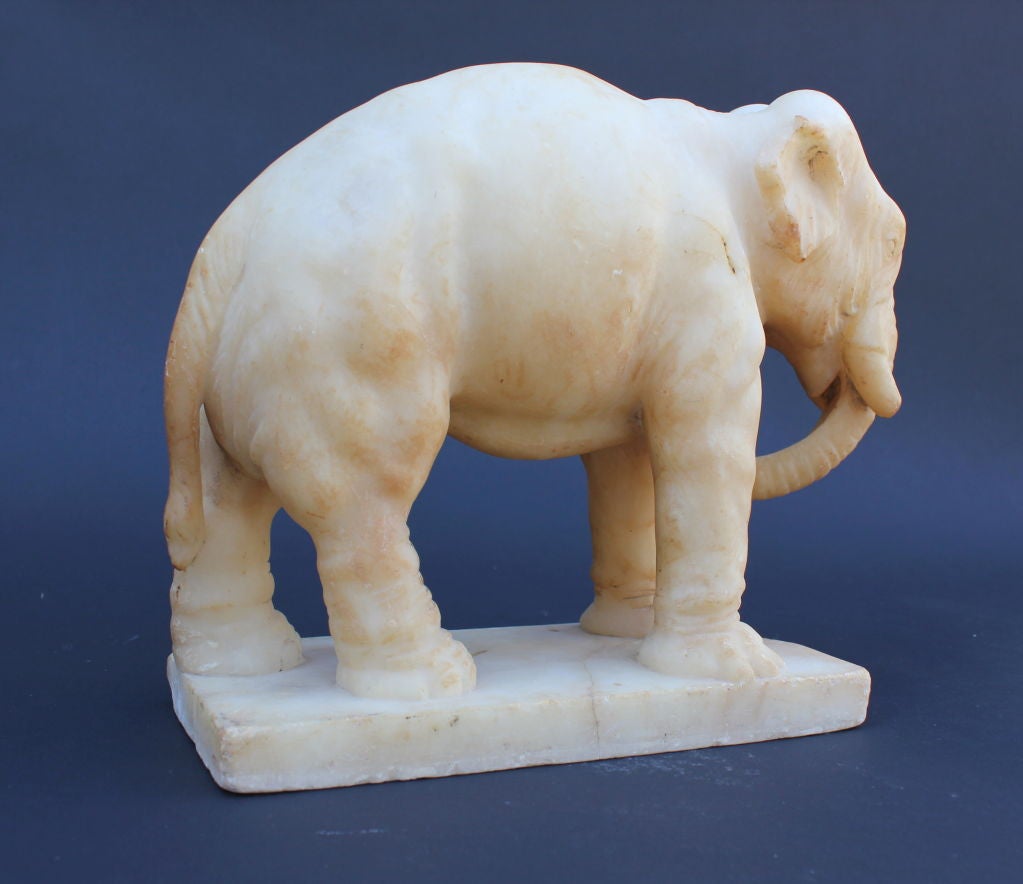 Beautifully Carved Alasbaster Elephant.  Great Musculature of the Elephant.  Some Condition issues.  One Ear Damaged. Loss to the base.