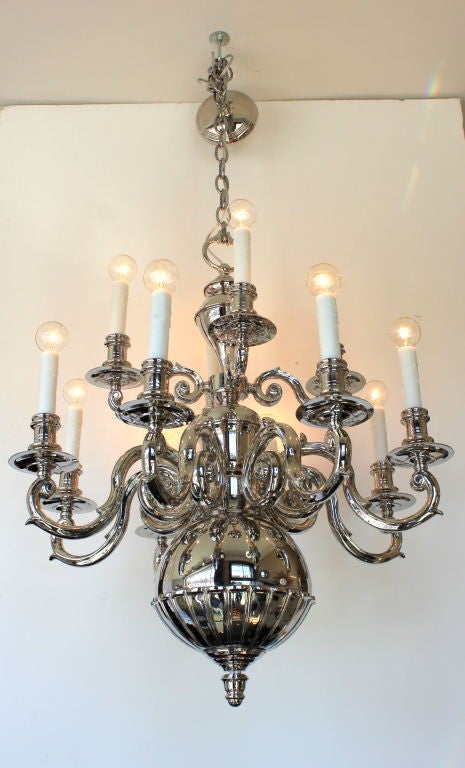 Two-tier 12-arm Dutch nickel over brass chandelier. Newly plated and rewired. Waxed candle covers.