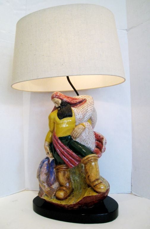 Large Majolica ceramic lamp depicting a fisherman. Custom linen oval lampshade included. Lampshade measures 18