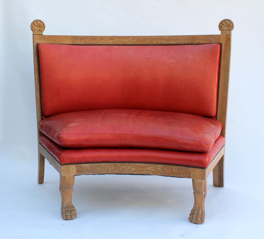 Pair of ceruse oak curved settees in the manner of Jean Charles Moreux in the, late 1930s. Later coral leather upholstery. Original finish.