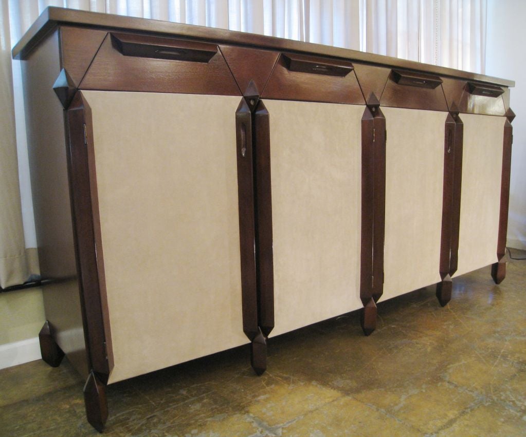 Unusual Italian Cabinet attributed to Giovanni Michelucci. The cabinet is walnut and the face of the four doors are covered in suede leather. The drawers are triangular in shape. Unusual leg. This cabinet is extremely well made.