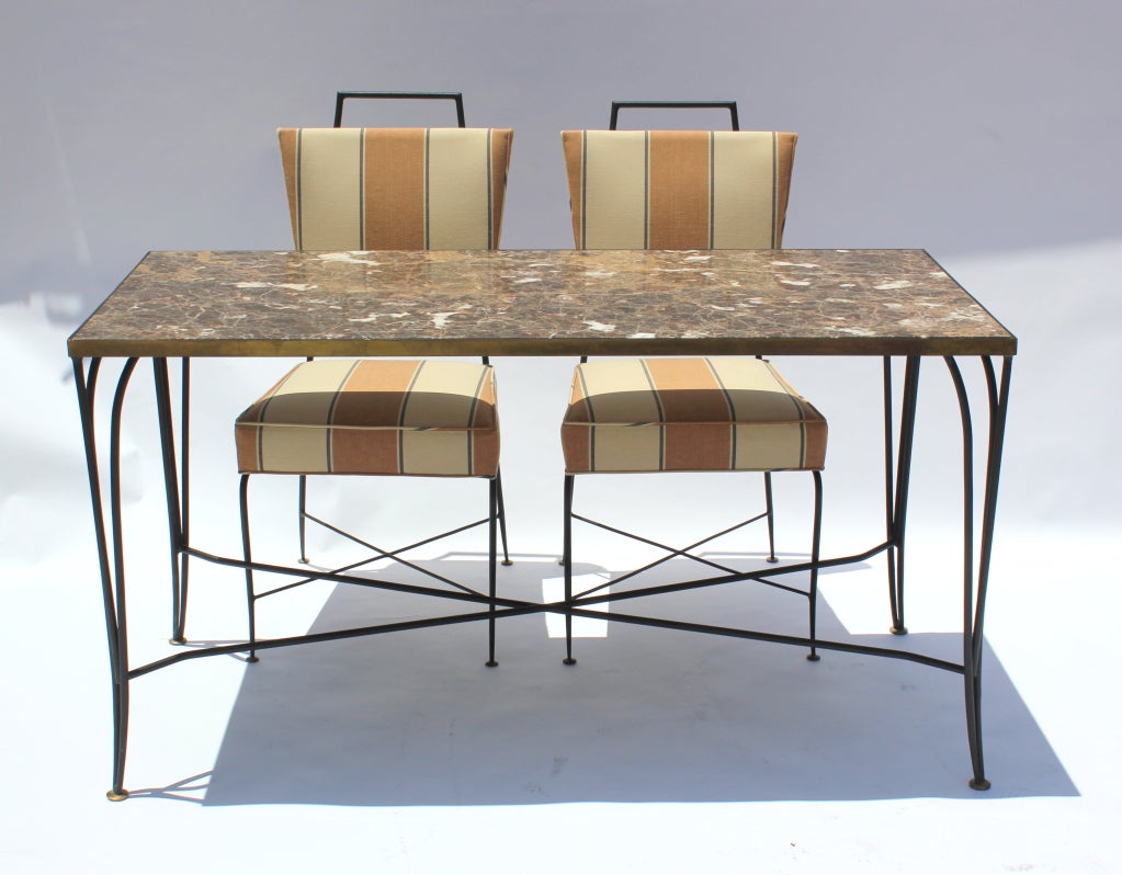 Arturo Pani iron and brass table and chairs. Inset marble top.
Table measures 53.5