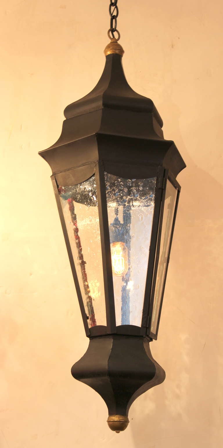 Pair of Large  Neoclassical  Style Lanterns originally designed for Outdoor use.  Can be used indoors or outdoors.  Rewired ,  Seed Glass.  Brass details.    