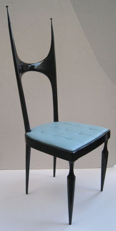 Pair of black lacquered chairs with exaggerated spire back.

Baby blue leather upholstered seats. Chairs are signed with metal tag. Often attributed to Ico Parisi.