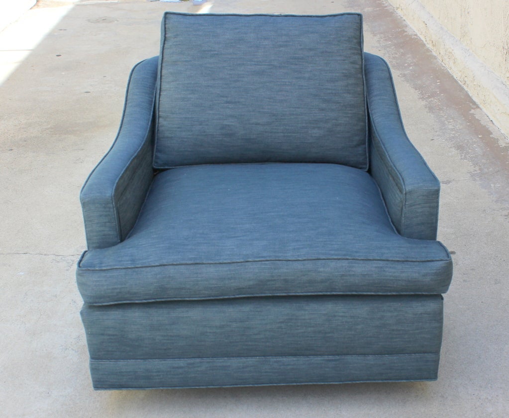 Pair of Monteverdi Young Swivel Chairs. Upholstered in Japanese Denim.  Feather back pillow.
