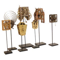 Collection of Seven Clock Skeletons mounted on Stands