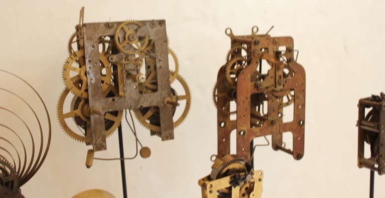 Metal Collection of Seven Clock Skeletons mounted on Stands
