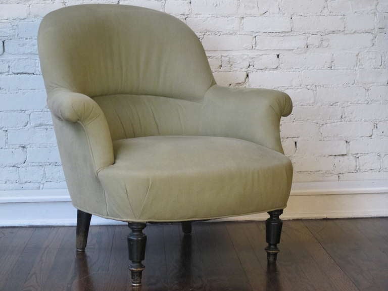19th Century French armchair with a very sturdy frame and ebonized legs. Currently upholstered in vintage gray cotton canvas. Similar larger armchair available.