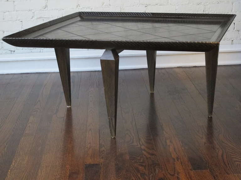 Dark-stained oak cocktail table by Romweber featuring an incised diamond-patterned top with a gadrooned frame, on tapered legs.