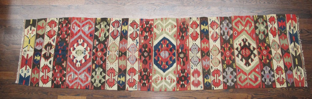 Brightly-colored handwoven wool Kilim carpet. Others available.