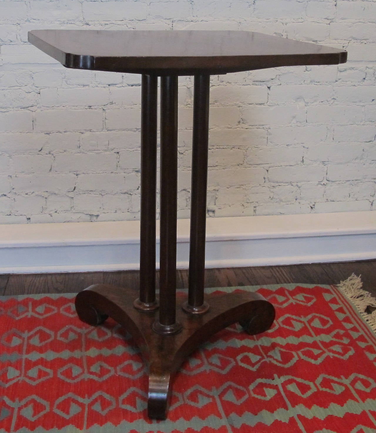 Mahogany side or tea table with veneered tripod base supporting solid mahogany columns and top. Refinished at some point and recently polished. Table height, would make a great nightstand or hall table as well.