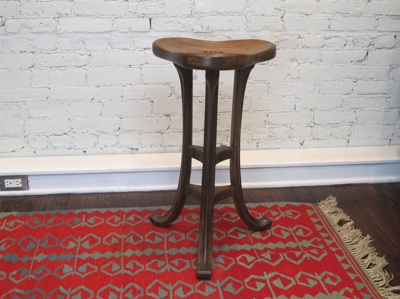 English mahogany stool with trefoil design including cut-out handle in top. Refinished at some point, with a pleasant patina from use. Very sturdy.