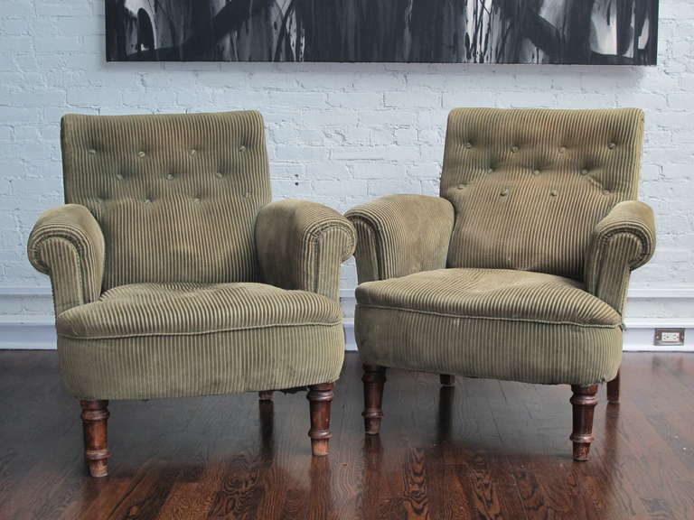 Pair of English armchairs with tight seats and tufted backs on mahogany legs. Unusually large in scale with great character. Price is for the pair.