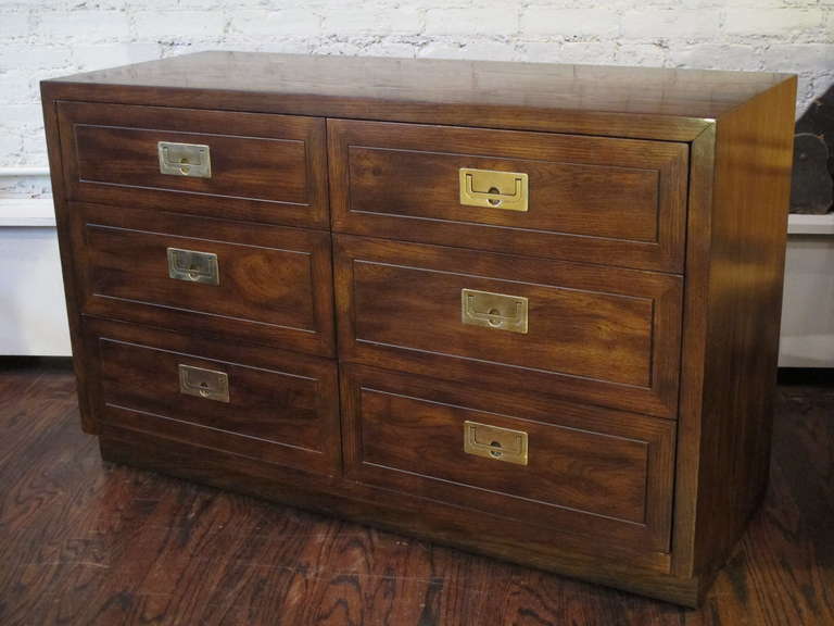 Mahogany chest with a golden, mottled finish, featuring recessed brass campaign style hardware. Matching bedside cabinets available.