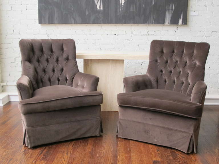 Pair of armchairs covered in brown cotton velvet with loose seats and tufted backs.  Price is for the pair.