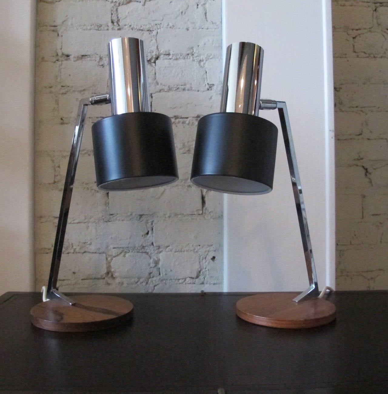Pair of Fog & Mørup desk lamps with rosewood bases, chrome arms and black-painted steel shades. Price is for the pair. Dimensions are variable as the shades pivot.
