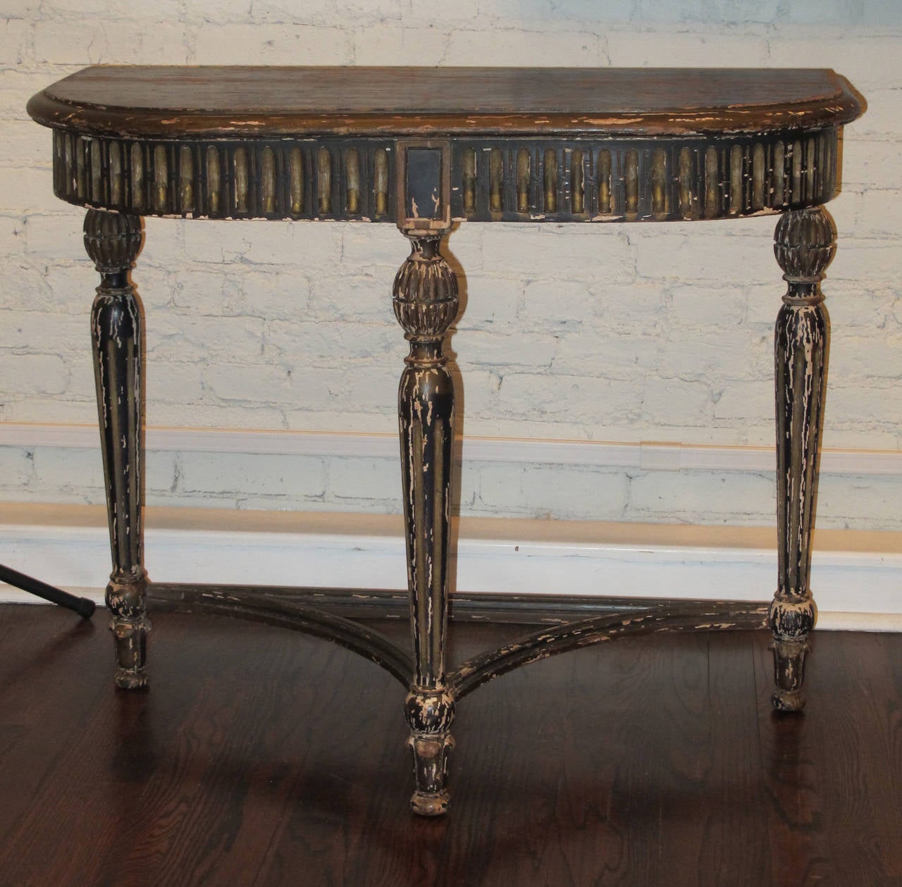 Midnight blue console table with losses to finish from age and use. Pleasant patina showing both the plaster beneath the paint and areas of the wooden structure. Table is very sturdy.