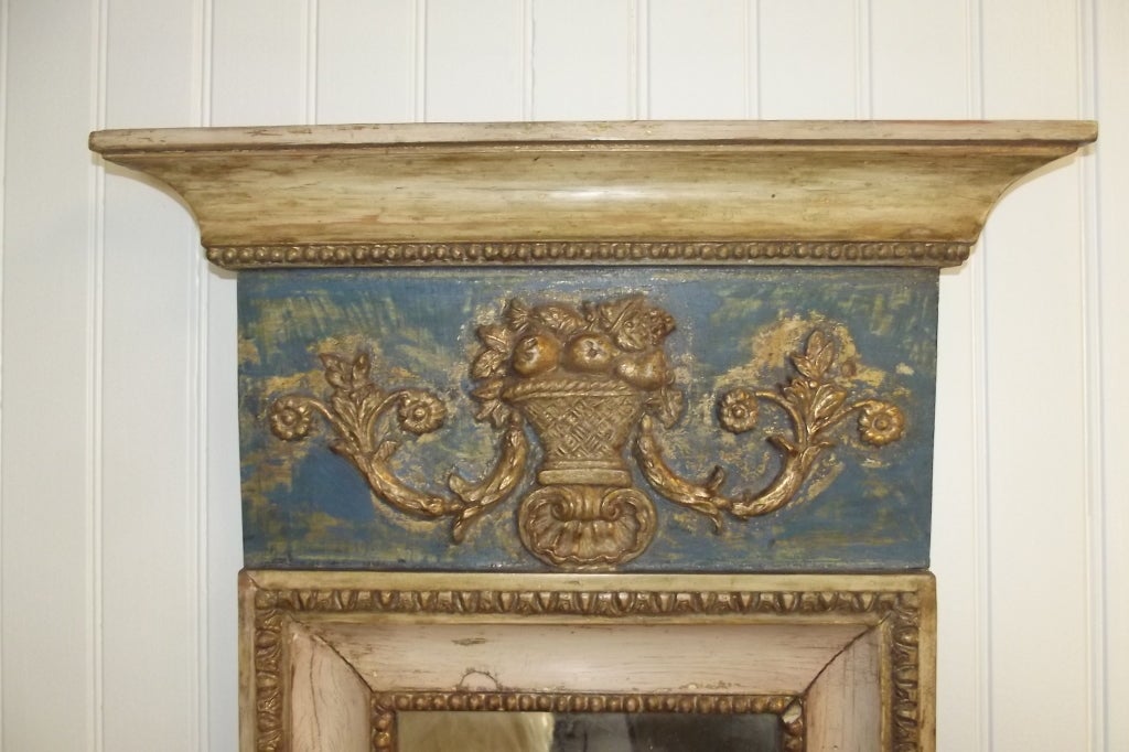 A late Gustavian mirror that has been cleaned to its origial blue, white and gilt surface.  Wonderful carving and detail, original looking glass, retains a wax seal on the back, probably a maker's mark.