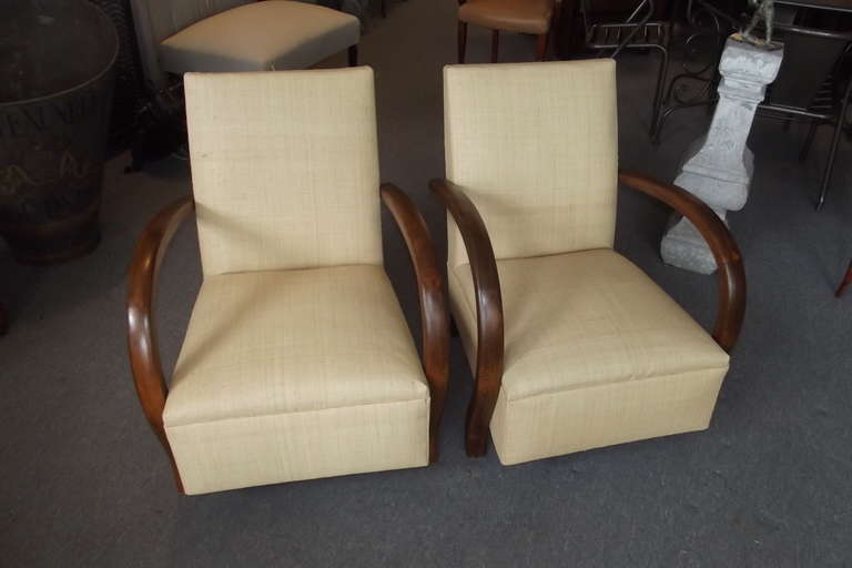A pair of French loop armchairs that have been newly upholstered in raffia and have had their arms and feet newly refinished.