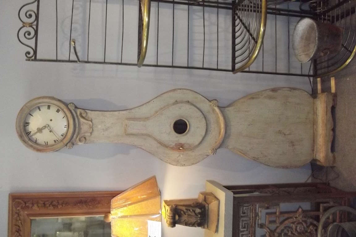 A period Swedish Gustavian tall case clock dating circa 1820.  The clock has its original off white painted surface which was restored when overpaint was professionally removed by dry scraping. The time and strike movement has been professionally