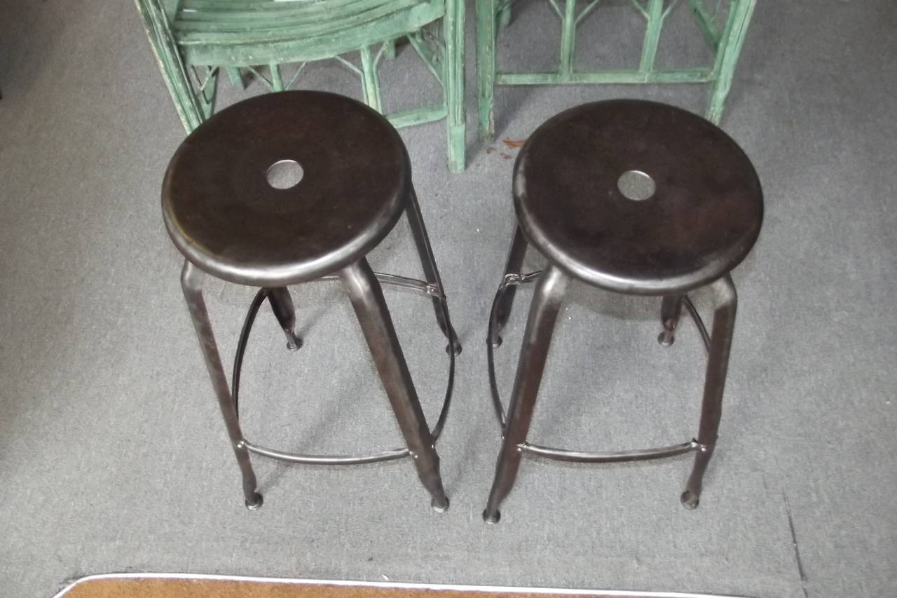A pair of French counter height stool newly polished and lacquered.