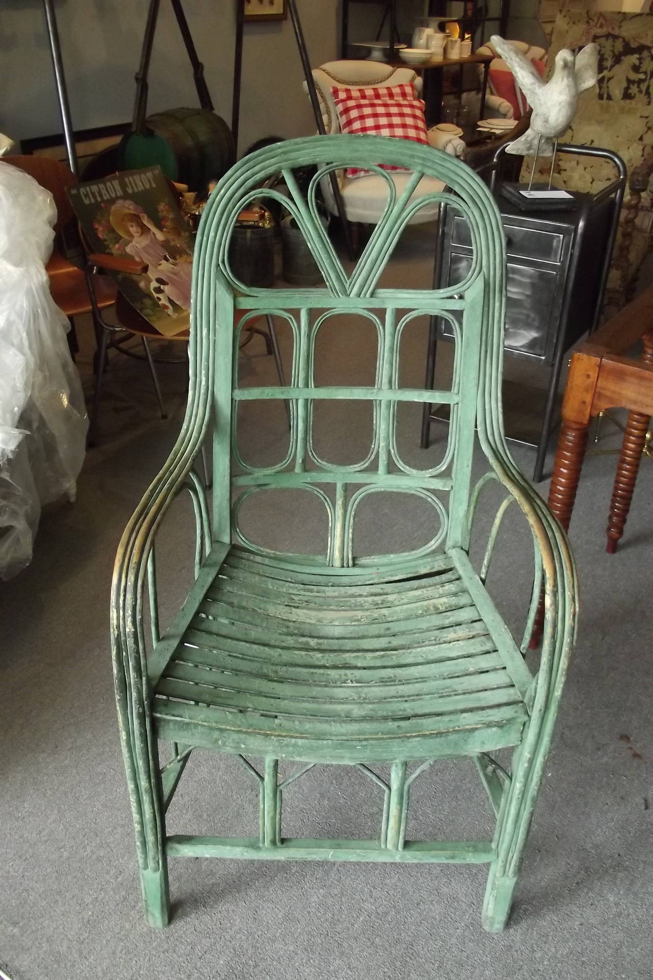 An pair of graphic French rattan chairs with an exceptional oxidized green surface.  These chairs date from the early 20th century and are in excellent overall structural condition with no breaks or losses.  The are very comfortable.