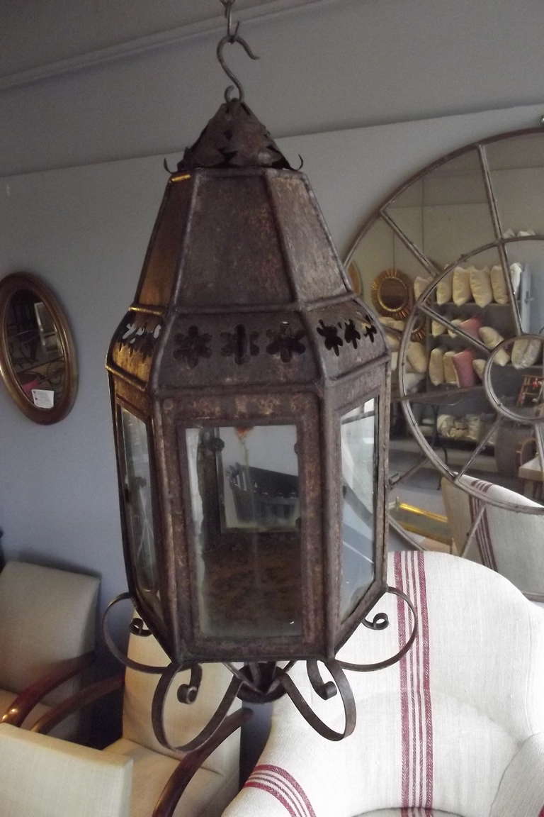 A hexagonal tin candle lantern in as found condition with an oxidized surface.  While in its original candle format it can be easily wired.